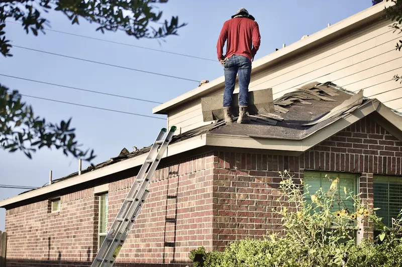 Professional roofer working on a residential roof in The Preserve